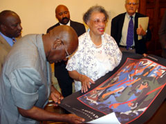 President Kabbah looking at an art work on the AMISTAD donated by the group