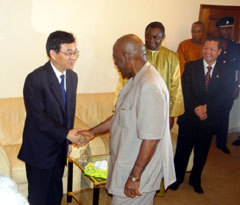 President Kabbah in handshake with Assistant Minister of Foreign Affairs, Mr. Lu Gouzeng