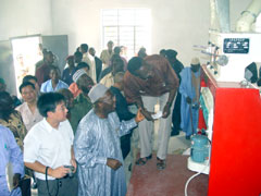 President Kabbah viewing a demonstration of the operation of the milling machine
