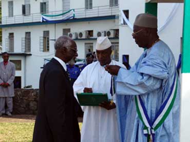President Kabbah awarding Prof. Kosonike Koso-Thomas 