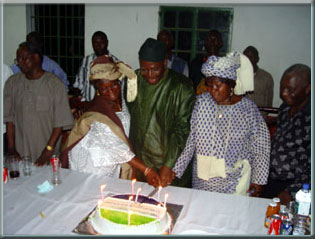 President Kabbah cutting his birthday cake with twin sisters of the late S.B.Marah, Tinah and Dondor