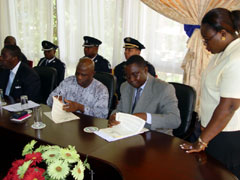 Momodu Koroma, Sierra Leone's Minister of Foreign Affairs and Counsellor Kabineh M. Janeh Attorney General and Liberia's Minister of Justice signing the joint  communique