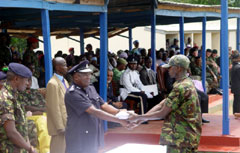 Inspector General of Police, Brima A. Kamara presenting a prize to a recruit