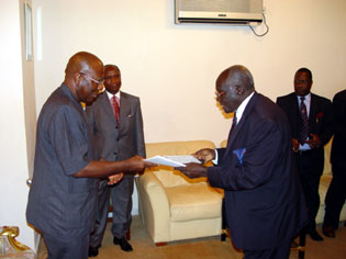 President Kabbah receiving a copy of the bank's annual report and accounts for the year 2003 from Board Chairman, Mr. Ibi May-Parker