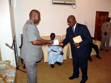 Acting Chairman of the Board of Directors, Alhaji Gibril presenting the cheque to President Kabbah