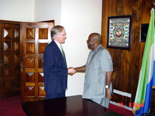 President Kabbah in handshake with Prosecutor of the Special Court for Sierra Leone, Mr. David Crane