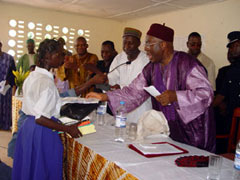 President Kabbah handing over cash, books anduniform to a girl child