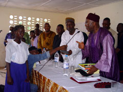 President Kabbah handing over cash, books anduniform to a girl child