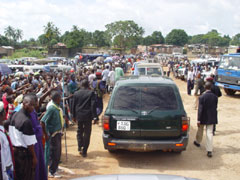 Crowds of people singing "wu-teh-teh" as president Kabbah's motor cade goes through the streets of Koidu Town