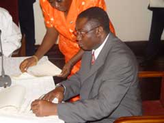 Momodu Koroma, Minister of Foreign Affairs and International Cooperation signing the communique